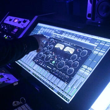 Luka adjusting a plugin while mixing a song.